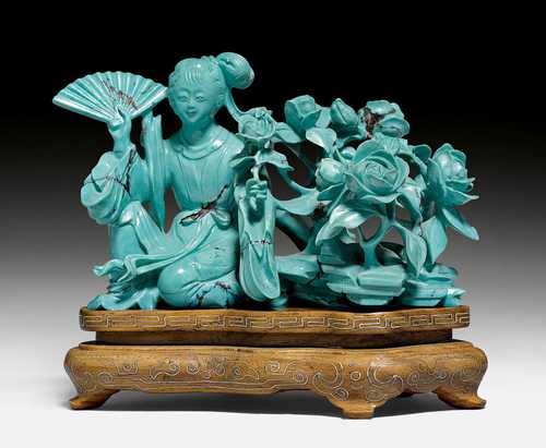 A FINE TURQUOISE CARVING OF A LADY WITH PEONIES.