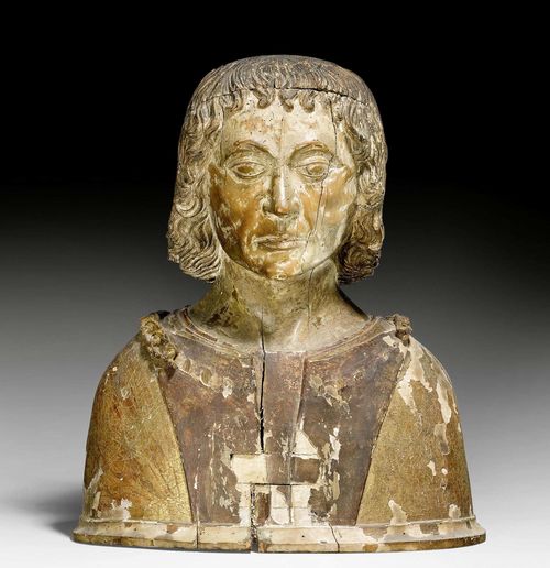 RELIC BUST,Renaissance, Burgundy / Savoy, 2nd half of the 15th century. Limewood carved full round, with remains of painting. In floral patterned robe with chain (incomplete). H 48 cm. Larger areas of loss, remains of a later painting.