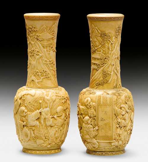 A PAIR OF IVORY VASES CARVED WITH PLAYING CHILDREN.