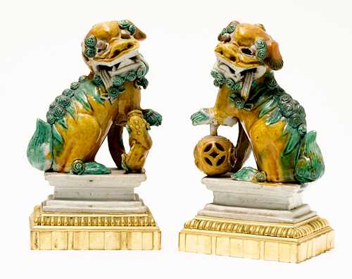 A PAIR OF FOO DOGS WITH BRONZE MOUNT,