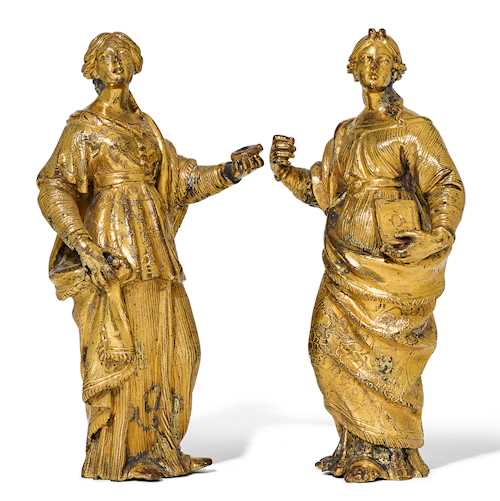 PAIR OF ORNAMENTAL FIGURES ON A BAROQUE CABINET