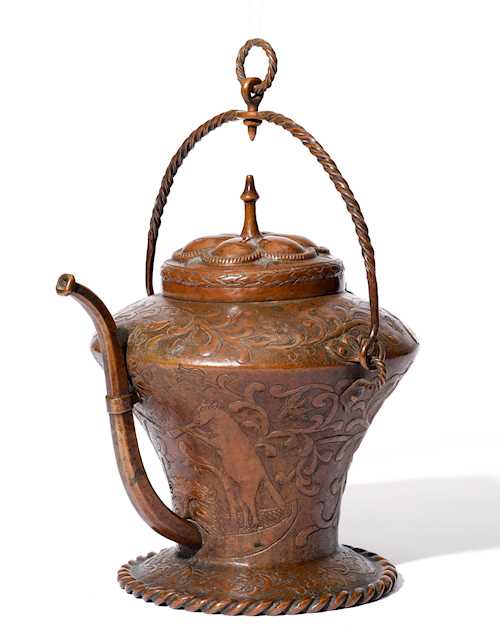 A CHASED COPPER PITCHER