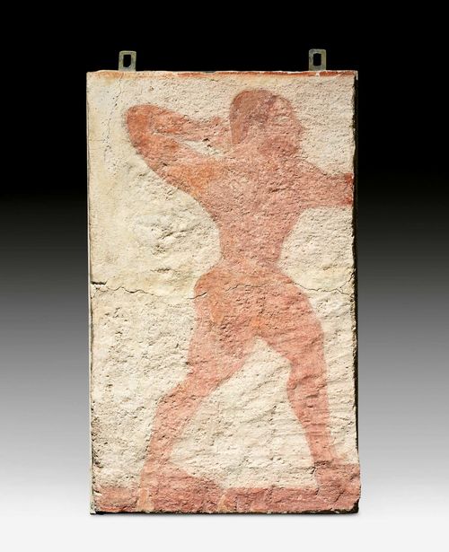FRESCO, Etruscan, 6th century B.C. Tuff stone with lime wash. Depicting a standing fighter. Restorations. H 62 cm. W 37 cm. Provenance: -From an Etruscan tomb in Tarquinia. - Galleria Casa Serodine, Ascona. - Swiss private collection, acquired 1962.