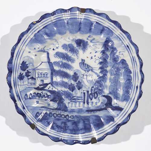 A FAIENCE FLUTED PLATE
