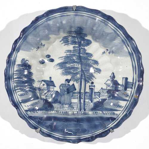 A FAIENCE FLUTED PLATE