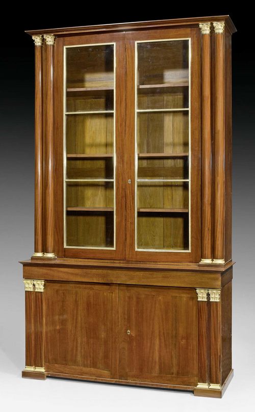 IMPORTANT BOOKCASE,Empire/Restauration, stamped IACOB (Francois Honore Georges Jacob-Desmalter, 1770-1841), the bronze probably by P.P. THOMIRE (Pierre-Philippe Thomire, 1751-1843), Paris circa 1825. Flame mahogany. The lower section with double doors under broad top drawer. Interior with 6 drawers "a l'anglaise". Exceptionally fine, matte and polished gilt bronze mounts and applications. 163x58x285 cm.