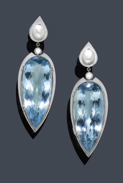 AQUAMARINE, NATURAL PEARL AND DIAMOND EAR PENDANTS. White gold 750. Fancy, matte-finished ear pendants with studs, each with a drop-shaped ornament, set with 1 button-shaped natural pearl weighing 3.43 ct. Below, two flexibly mounted pendants, each with 1 large, fine drop-cut aquamarine weighing. 73.64 ct, and additionally decorated with 1 brilliant-cut diamond weighing ca. 0.30 ct. each. L ca. 6 cm. Pearls with SSEF Report No. 51941, 2008. With case.