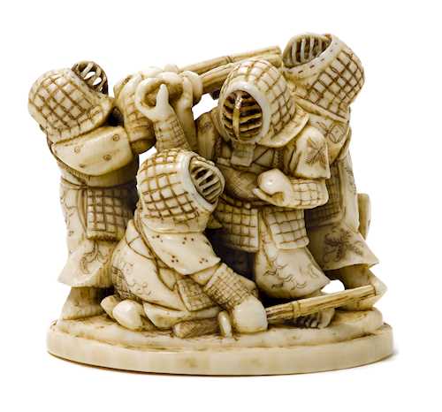 AN IVORY OKIMONO OF KENDO FIGHTERS.