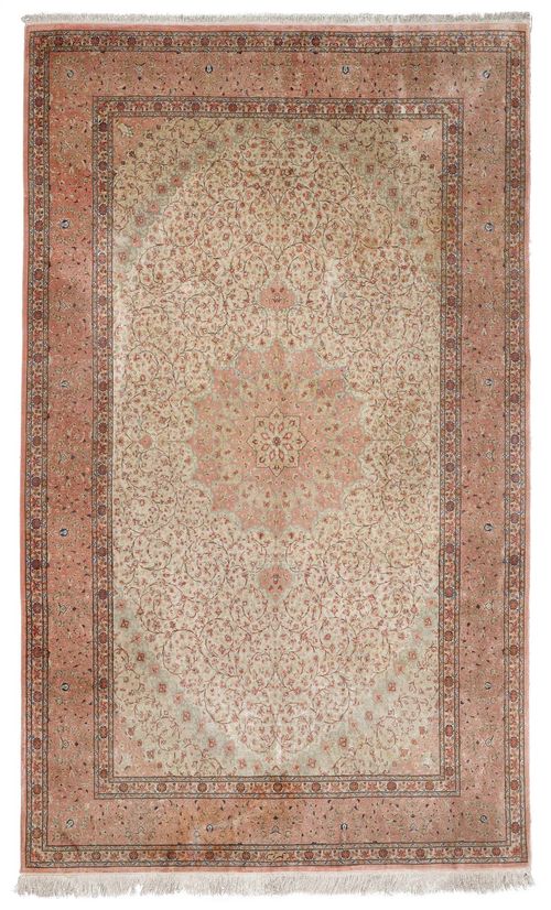 GHOM SILK old.Beige central field with a pink central medallion and light green corner motifs, the entire carpet is finely patterned with trailing flowers in delicate pastel colours, pink border, 195x303 cm.