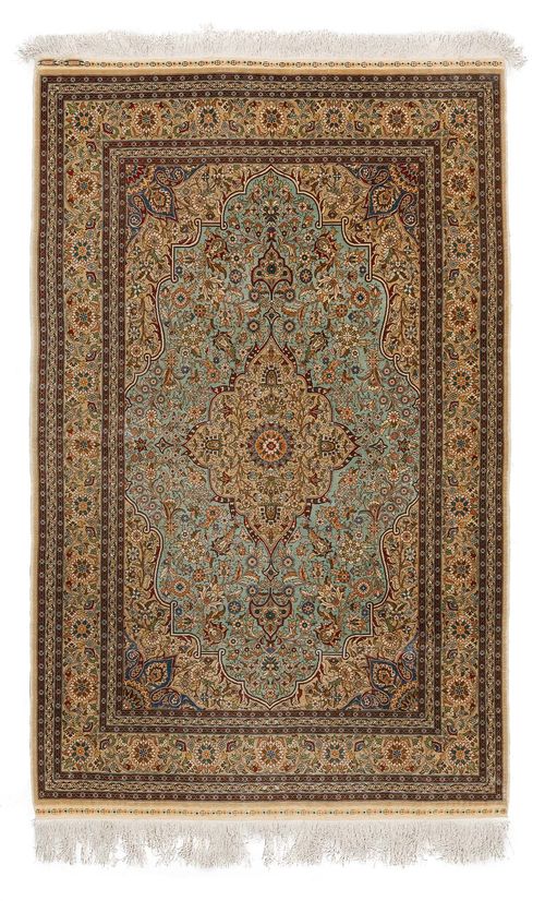HEREKE SILK.Turquoise central field with a beige central medallion, the entire carpet is patterned with trailing flowers and palmettes, beige edging with trailing flowers, signed Derintchi, 103x156 cm.