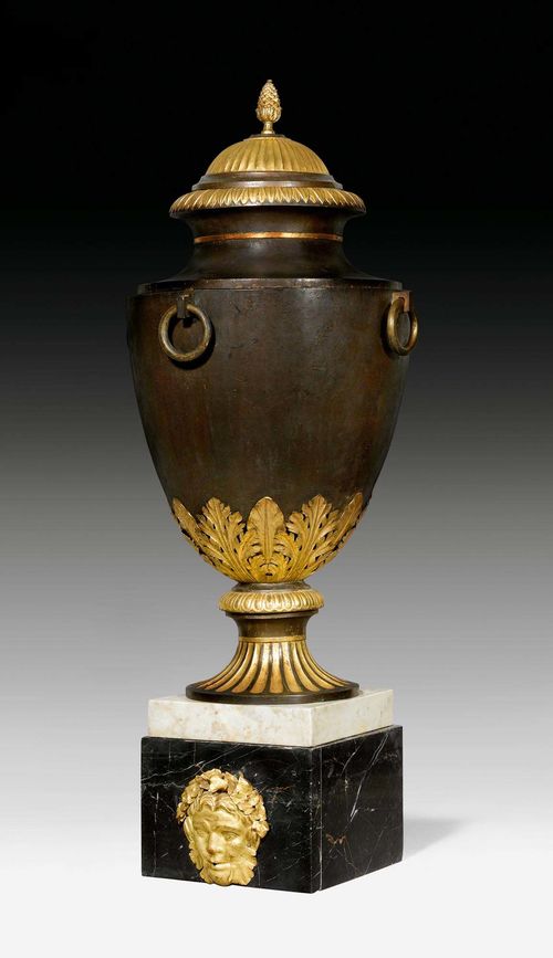 IMPORTANT VASE AND COVER,known as a "reserve et deversoir de fontaine", Directoire, Paris circa 1800. Gilt and burnished brass. The plinth partly of white and black marble.  Chips. H 122 cm. Expertise by Cabinet Dillee, Guillaume Dillee/Simon Pierre Etienne, Paris 2012.