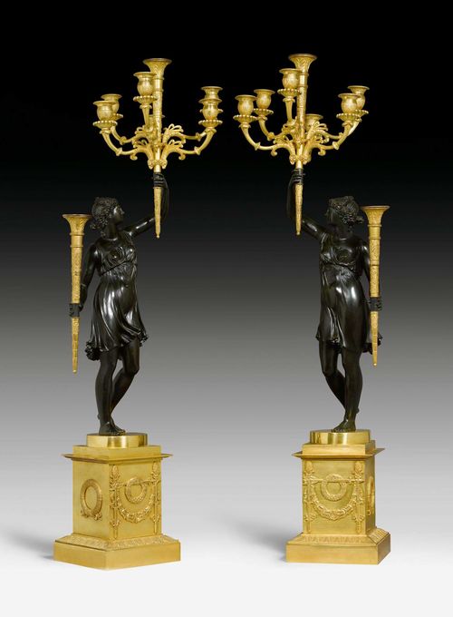PAIR OF IMPORTANT CANDELABRA "PORTE-FLAMBEAUX",Empire, the model by P.F. FEUCHERE (Pierre-Francois Feuchere, 1737-1823), Paris circa 1810. Gilt and burnished bronze. 2 slightly different, standing young women, each carrying 2 torches. Gilt mounts and applications. H 100 cm.