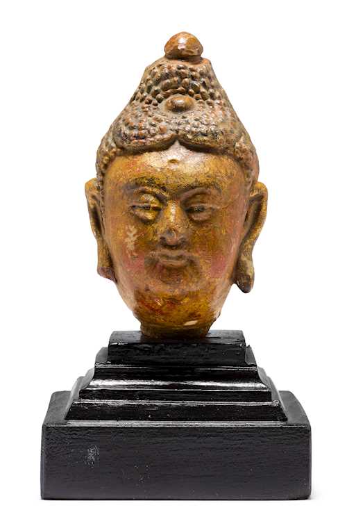 A POLYCHROME STUCCO HEAD OF BUDDHA.