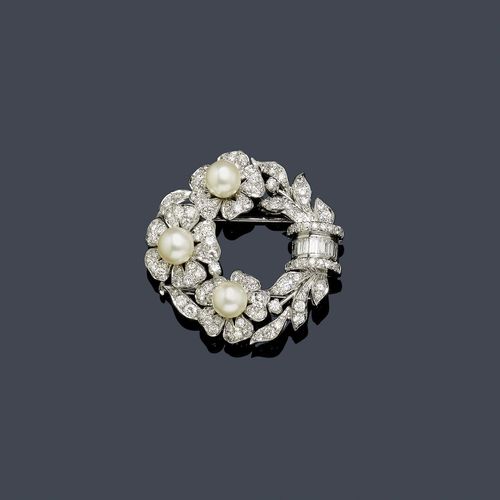 DIAMOND AND PEARL CLIP BROOCH, BULGARI, ca. 1950. White gold 750. Round brooch designed as a wreath of flowers, each blossom decorated in the centre with 1 Akoya cultured pearl of ca. 7 mm Ø, and set throughout with 75 brilliant-cut diamonds weighing ca. 1.80 ct in total, the leaves decorated with 34 brilliant-cut diamonds weighing ca. 1.00 ct in total, and the ornamental band set with 5 baguette-cut diamonds and 18 brilliant-cut diamonds weighing ca. 0.70 ct in total. Signed Bulgari. Ca. 3.9 cm Ø. With case.