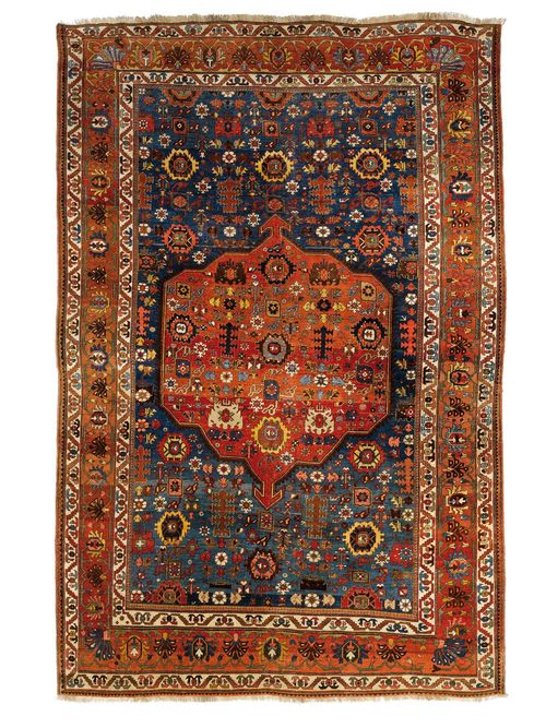 BIDJAR antique.Blue ground with dusky pink central medallion, patterned with star motifs, wide border in dusky pink with trailing flowers, 235x335 cm.