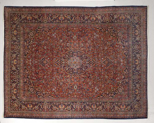 KAZVIN antique.Red ground with a central medallion, patterned with trailing flowers and palmettes, blue border, 265x355 cm.