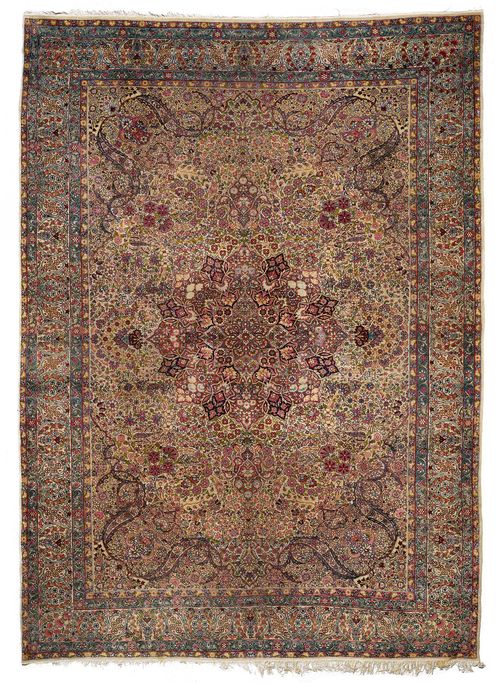 KIRMAN LAVER antique.White central field with a central medallion, opulently patterned with colourful trailing flowers, white border, strong signs of wear, 270x380 cm.
