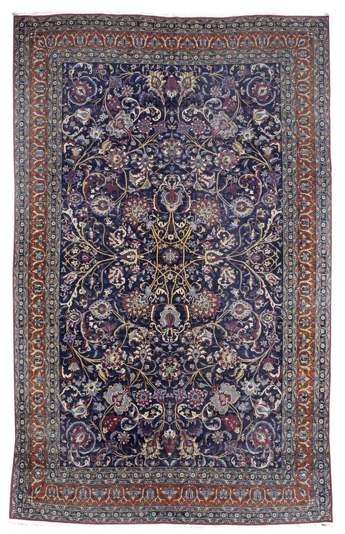 TEHERAN antique. Dark blue central field with trailing flowers and palmettes in harmonious colours. Red main border with stylized tendrils. Some areas slightly worn. 260 x 275 cm.