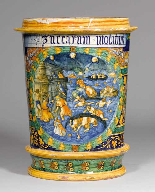 IMPORTANT, LARGE 'MAJOLICA' PORCELAIN 'ISTORIATO' ALBARELLO  'A QUARTIERI', Faenza, ca. 1540-1550. Cylindrical, slightly conical vessel with circumferential profiled rings on the top and bottom. The front with a scene depicting the Biblical Deluge, framed by a green laurel wreath with yellow fruit, on a background of tendril borders with grotesque figures in blue, yellow and green in the 'Quartieri' style. The top of the scene is adorned by an inscription accentuated in white and blue: 'ZUCCARUM MOLATUM'. Remains of old provenance labels 'Collection Scalea'. H 49 cm, D 33 cm. Small repairs and some chipping of the glaze. Provenance: - Collezione dei Principi Lanza di Scalea, Palermo. - Private collection, Rome. This highly dramatic scene depicts the climax of the Biblical Deluge. The left of the foreground features Noah's Ark with some desperate rejected people attempting to scale the side of the boat in the heart of the flood swallowing those remaining. For this scene, the painter obviously used a copper engraving attributed to Francesco Rosselli (Florence, 1448 -1513) from ca. 1470/90, presently in the British Museum. The main motif of this scene, i.e. the male figure dressed in a loincloth and scaling the Ark is probably the King of the Giants, Org, who apparently saved himself in this manner and was provided with food for months by Noah who took pity on him. For the most part, the painter of the 'albarello' adhered  to the details of the copper engraving, and transferred them to the 'albarello'. (Martin Schawe, Sündflut, in: Aviso, Zeitschrift für Wissenschaft und Kultur in Bayern, 4/2013, pages 12-19). CHF 90 000.- / 120 000.- € 75 000.- / 100 000.-