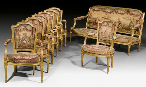 TAPESTRY SUITE OF FURNITURE,Louis XVI, partly stamped A. GAILLIARD (Antoine Gailliard, maitre 1781), Paris circa 1780. Comprising: 1 three-seater canape "a la reine" and 6 fauteuils "en cabriolet." Fluted, carved and gilt beech. Fine tapestry covers from the  Manufacture de Beauvais with fable scenes from Lafontaine and figural scenes. Gilding renewed and chipped in parts. Canape 180x50x38x98 cm. Fauteuils 58x52x40x90 cm.
