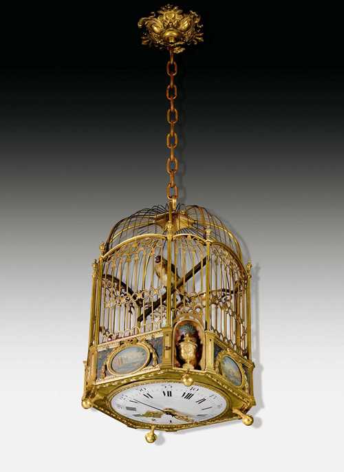 BIRD CAGE CLOCK WITH MUSIC BOX,Louis XVI, the circle around JAQUET-DROZ (Pierre Jaquet-Droz, 1721-1790) and H. MAILLARDET(Henri Maillardet, born 1745), La Chaux-de-Fonds circa 1800. Gilt bronze, brass and painted metal. The base painted with landscape scenes in medallions, flowers, volutes and cartouches. Enamel dial underneath. 1 blued and 2 fine gilt hands. The movement with 4/4 striking on 2 bells. The cage with a sitting, singing and moving goldfinch. 1-hour trigger with different melodies. Drive mechanism with bellows and 10 tin pipes. The movement requires servicing. The dial chipped. H 50 cm. Provenance: Swiss private collection. An automaton clock of the highest rarity and outstanding quality, as they are actually known only from Jaquet-Droz and H. Maillardet.