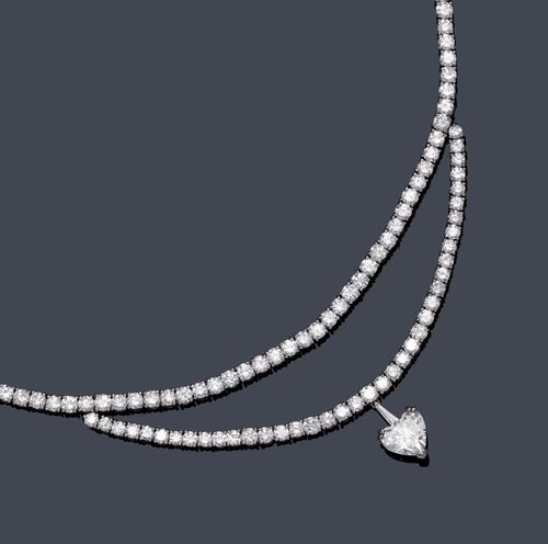 DIAMOND NECKLACE, ca. 1950. White gold 585. Classic-elegant Rivière necklace, the front set with a total of 196 brilliant-cut diamonds weighing ca. 17.50 ct in a double row setting, and additionally decorated with a diamond heart pendant of ca. 2.10 ct ca. J/VVS, flexibly mounted by a small trapeze-cut diamond. L ca. 46.5 cm. With copy of estimate, March 2012.