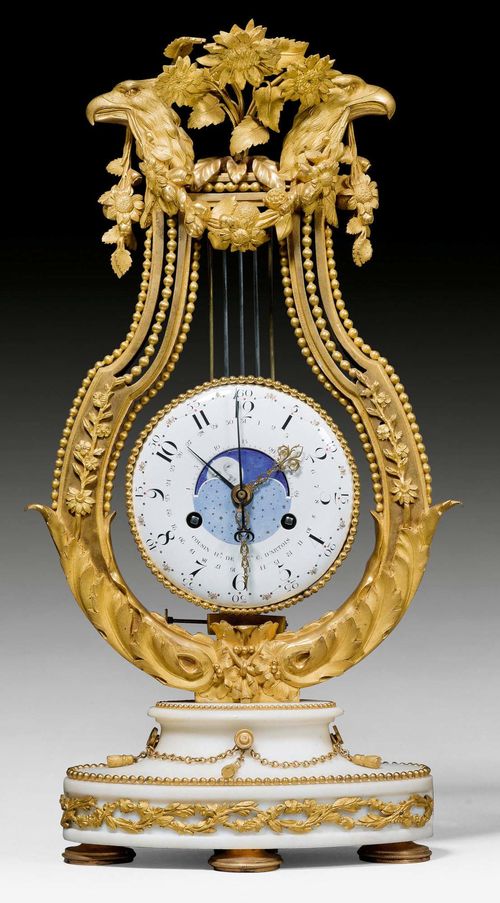 FREISCHWINGER LYRE CLOCK WITH MOON PHASE,Louis XVI, the dial signed COUSIN HR DE MGR. C. D'ARTOIS (Joseph Simon Cousin, maitre 1778) and COTEAU A PARIS (Jean Coteau, emailleur, Geneva 1740-1801 Paris), Paris circa 1785. White marble with matte and polished gilt bronze. Finely painted enamel chapter ring set with paste stones. Fine, parcel gilt and pierced steel hands. Exceptionally finely painted moon phase. Anchor escapement striking the 1/2 hours on bell. 28x10x57 cm. Provenance: private collection, Ticino. A highly important and extremely rare clock of impressive quality. Illustrated in: J.O. Scherer, Antike Uhren, Stuttgart o.J.; Table XV.