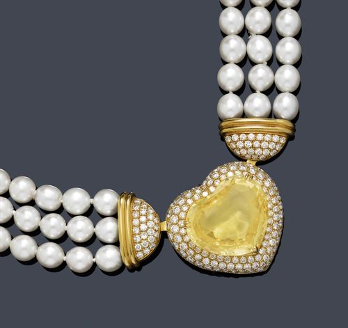 SAPPHIRE, DIAMOND AND PEARL NECKLACE. Yellow gold 750. Fancy, three row necklace of numerous Akoya cultured pearls of ca. 8 mm Ø, attached to the top by means of 2 half-round attaches set throughout with 48 brilliant-cut diamonds weighing ca. 1.30 ct. L ca. 40 cm. The centre part set with 1 very fine, heart-shaped, yellow sapphire weighing ca. 54.00 ct, unheated, the setting with numerous pavé-set brilliant-cut diamonds weighing ca. 3.00 ct. Can also be used as a pendant. Tested by Gemlab. Matches the following lots.