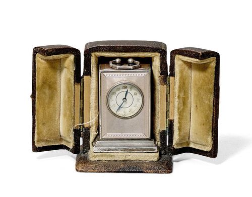 ENAMEL MINI PENDULETTE, VACHERON & CONSTANTIN, Geneva, ca. 1920. Sterling silver. Rectangular, engine-turned case No. 3091 875, enamelled dusky pink, with ray motifs and zigzag borders. Silver base. Textured dial with appliqued, gold-coloured numerals and blued hands, outer minute division with gold dots, the back engraved: Fabriqué pour Vacheron & Constantin, Genève, No. 875. Lever movement with Breguet spring, bimetallic balance, unsigned. Key winder, with key. Ca. 4.6 x 2.8 x 2 cm. With brown case, unsigned.