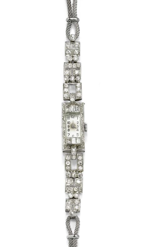 DIAMOND LADY'S WRISTWATCH, ca. 1930. Platinum and white gold. Rectangular case with finely engraved sides, lunette set with 6 baguette-cut diamonds weighing ca. 0.40 ct and set throughout with numerous single-cut diamonds. Silver-coloured dial with Arabic numerals and blued hands. Manual winding, form movement, Swiss made. Diamond-set band with square motifs, graduated. Total weight of the diamonds ca. 2.20 ct. Bracelet of braided cord in white gold, not original. L ca. 18 cm.