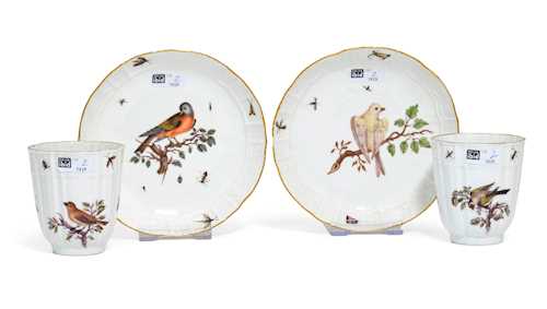 A PAIR OF CHOCOLATE CUPS AND SAUCER WITH A BIRD PAINTING