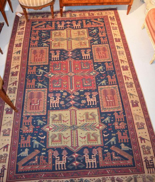AKSTAFA old.Blue ground with three medallions, geometric pattern with stylized plants and animals, beige border, 176x263 cm.