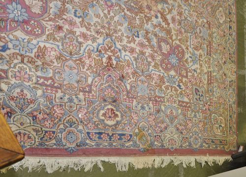 AMRITSAR old.Beige ground, richly patterned with floral motifs in soft pastel colors, light blue border, 274x370 cm.