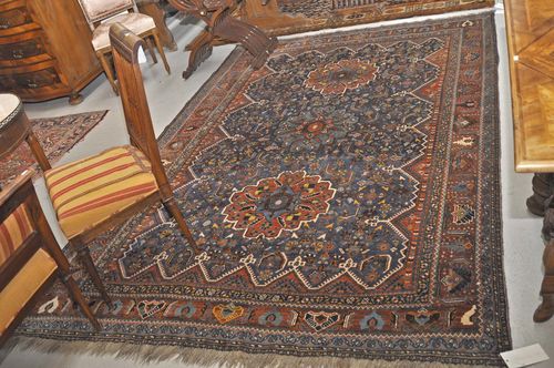 GASCHGAI old.Blue central field with three flower-shaped medallions, patterned with stylized plant motifs, rust-colored border, 192x287 cm.