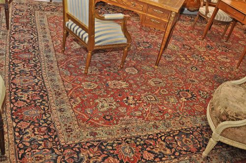 PERSIAN antique.Red central field patterned throughout with flowers and palmettes in soft pastel colors, dark blue border, heavy traces of wear, 340x470 cm.