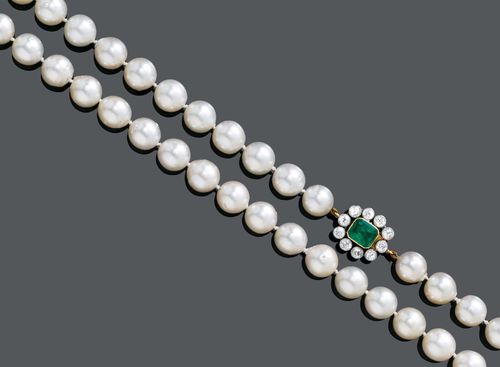 EMERALD, DIAMOND AND PEARL SAUTOIR, ca. 1950. Platinum 950, yellow gold 585 and 750. Two classic-elegant necklaces of 48 and 32 slightly baroque, Akoya cultured pearls of ca. 10-10.3 mm Ø, with a clasp integrated into a pearl. The shorter necklace with an additional clasp with 1 step-cut emerald, weighing ca. 1.50 ct, within a border of 10 old European-cut diamonds, weighing ca. 1.50 ct in total. L ca. 55.5 and 40 cm, respectively.