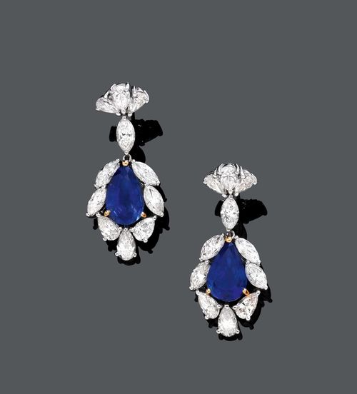 SAPPHIRE AND DIAMOND EAR PENDANTS, ca. 1950. White gold 750. Classic-elegant ear pendants with studs, each set with 1 fine, drop-shaped Ceylon sapphire, weighing ca. 7.60 ct in total, untreated, within a border of 4 navette-cut diamonds and 3 drop-cut diamonds, and flexibly suspended by 1 navette-cut diamond from a fan-shaped stud with 3 drop-cut diamonds. Total diamond weight ca. 8.10 ct. L ca. 3.6 cm.