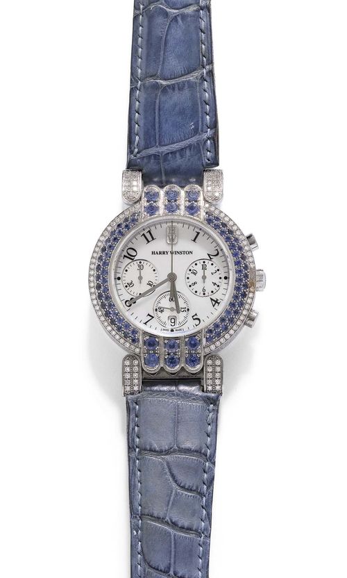 SAPPHIRE AND DIAMOND LADY'S WRISTWATCH, CHRONOGRAPH, HARRY WINSTON. White gold 750. Ref. 200/MCQB37WW, Premier model. Gold case 006001 No. 042 and attaches set throughout with numerous diamonds weighing ca. 1.40 ct. Lunette set throughout with sapphires weighing ca. 2.80 ct. Mother-of-pearl dial with black Arabic numerals and silver-coloured hands, 2 silver-coloured chrono pushers, small second and date at 6h. Quartz movement. Light blue leather band with fold-over clasp. With copy of invoice, November 2002.