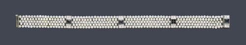 NATURAL PEARL AND SAPPHIRE BRACELET, ca. 1910. Platinum. Fine, five-row bracelet of numerous natural pearls of ca. 2 to 2.5 mm Ø and additionally decorated with 4 barrette intermediate links, each with 1 square-cut sapphire and 4 old European-cut diamonds, total weight of the diamonds ca. 0.20 ct. L ca. 17.5 cm. With contemporary case, signed Charlton & Co. New York, Paris.