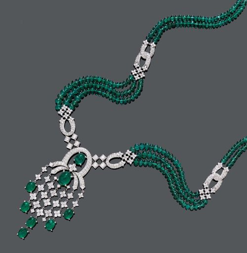 EMERALD AND DIAMOND NECKLACE. White gold 750, 70g. Very decorative, multi-row necklace of numerous emerald spheres of 3.5 to 5 mm Ø, with a diamond-set clasp and diamond-set intermediate links. The geometrically designed centre part set with 8 oval emerald cabochons and set throughout with numerous brilliant-cut diamonds. Total weight of the emeralds ca. 119.00 ct and total weight of the diamonds ca. 8.00 ct. L ca. 51.5 cm.