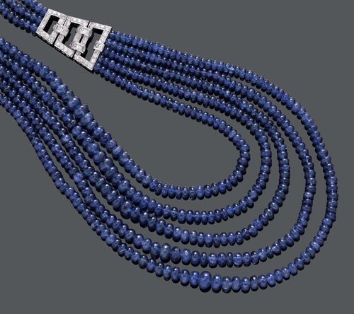 SAPPHIRE AND DIAMOND NECKLACE. White gold 750. Classic-elegant, three-row and five-row necklace of numerous graduated facetted sapphire beads of ca. 3.4 to 7.6 mm Ø, decorated with 2 geometrically open-worked ornamental elements, set throughout with 48 baguette-cut diamonds and numerous brilliant-cut diamonds. Clasp additionally decorated with 19 brilliant-cut diamonds. Total weight of the sapphires ca. 609.00 ct, total weight of the diamonds ca. 3.50 ct. L ca. 42 cm.