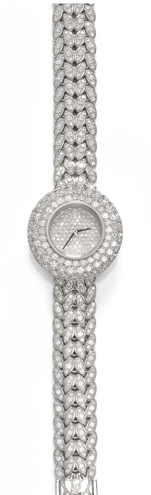 DIAMOND LADY'S WRISTWATCH AUDEMARS PIGUET, 1980s. White gold 750. Ref. BC 66976/Z/1069BC/01. Very fancy model, set throughout with diamonds weighing ca. 7.50 ct. Round case No. E07939 with adjustment button on the back. Diamond dial with black hands, signed AP. Hand winder, movement 466103, Cal. 2601, signed. Elegant bracelet with stylized, diamond-set leaf motifs, L ca. 15.5 cm. D 26 mm. With 2 extension elements measuring ca. 2.8 cm together, case, certificate of origin and warranty, and copy of the insurance estimate, December 1998.
