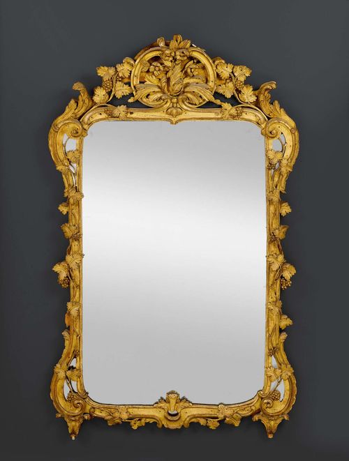 MIRROR, Regence/Louis XV, Paris circa 1730/50. Richly carved giltwood. Gilding chipped in parts. H 170 cm. W 100 cm.