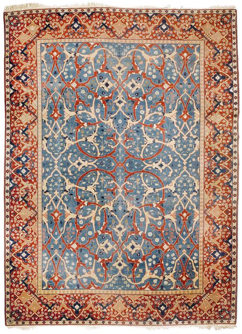 TABRIZ antique.Blue central field patterned throughout with trailing flowers and palmettes in beige and red, red border, signed: Ghali Baffian Mohammad Fajui Jabarzadeh, very good condition, 340x460 cm.