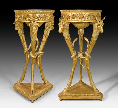 PAIR OF PORTE-TORCHERES "AUX TETES DE BELIER", Louis XVI, after designs by G.B. PIRANESI (Giovanni Battista Piranesi, 1720-1778), Rome circa 1800. Exceptionally finely carved gilt wood. Round "Lumachella Grigia" top. Some losses, some restoration required. H 137 cm. Provenance: from a highly important European private collection.