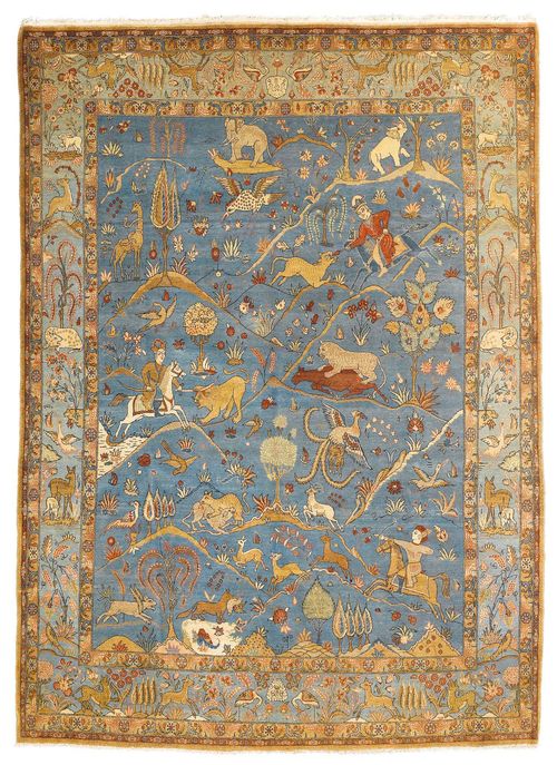 GHOM old.The blue central field is patterned throughout with hunting motifs in delicate pastel colours. Slightly worn, 237x303 cm.