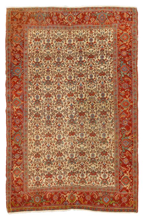 HERIZ antique. With a white ground decorated throughout with stylised plants and a red border. With areas of heavy wear, 140x190 cm.