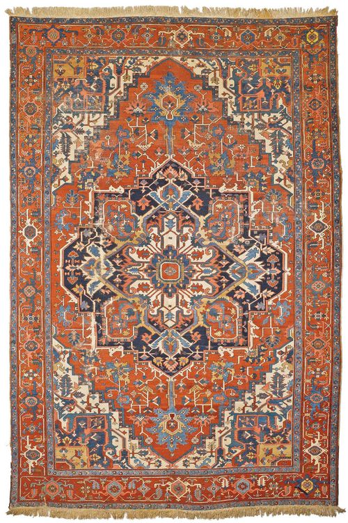 HERIZ SERAPI antique. With a large central medallion on a red ground with white corner motifs, patterned in the typical manner and with a red border. With areas of heavy wear, 293x405 cm.
