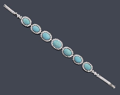 TURQUOISE AND DIAMOND BRACELET, ca. 1970. White gold 750, 28g. Decorative bracelet,  the front set with 7 graduated oval turquoise cabochons of ca. 9.5 x 7 to 11 x 9 mm, graduated, within a border of numerous brilliant-cut diamonds weighing ca. 2.30 ct, set in platinum, 1 missing. L ca. 17 cm.
