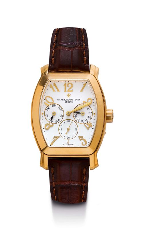 GENTLEMAN'S WRISTWATCH, AUTOMATIC, CALENDAR, VACHERON & CONSTANTIN, ROYAL EAGLE. Yellow gold 750. Ref. 42008/2. Tonneau-shaped case No. 796431 with screw-down back and stepped attaches. Silver-coloured dial with applied Arabic numerals and gold -coloured hands, date at 3h, small second at 6h, day in English at 9h. Automatic, movement No. 957327, Cal. 1206, gold rotor. Brown leather band with gold Vacheron clasp, No. 0500/7. D 36 x 49 mm. With wooden pin for setting the calendar.